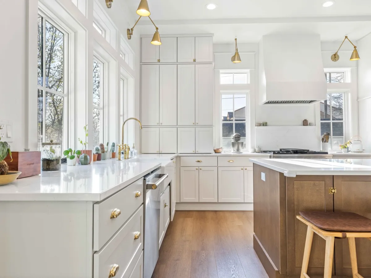 Kitchen with white cabinetry and a large island, daylight view