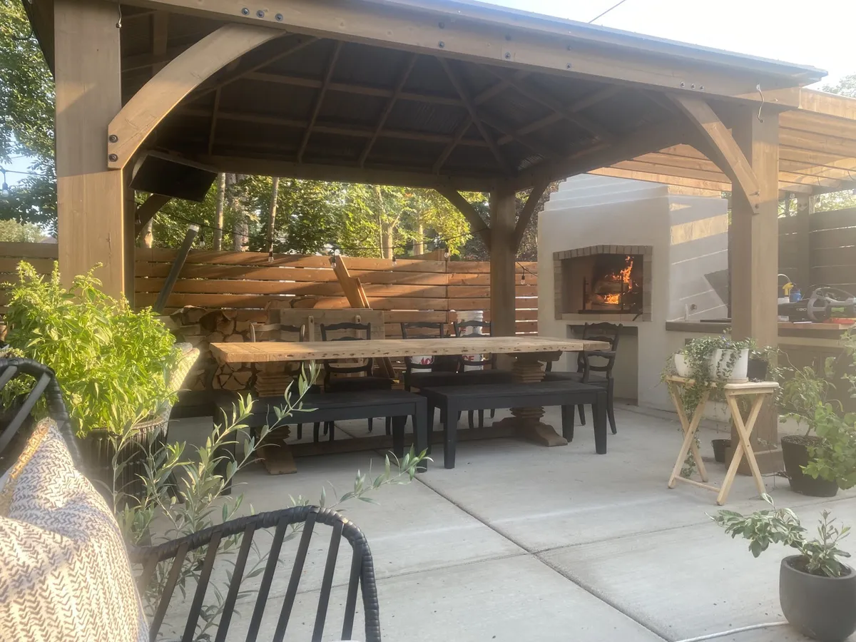 Outdoor kitchen with a built-in wood-fired pizza oven