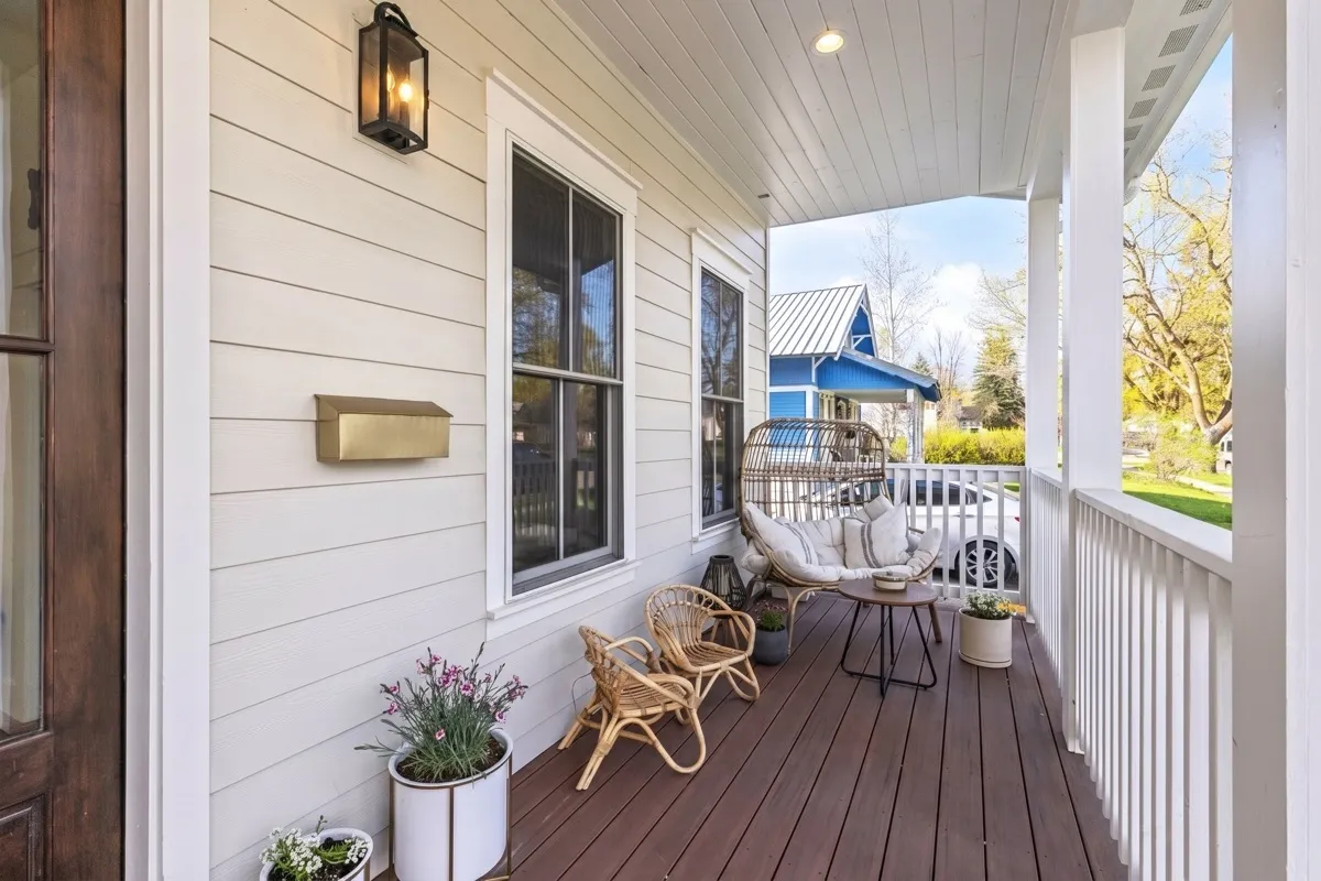 Detail of a craftsman-style wraparound front porch and columns