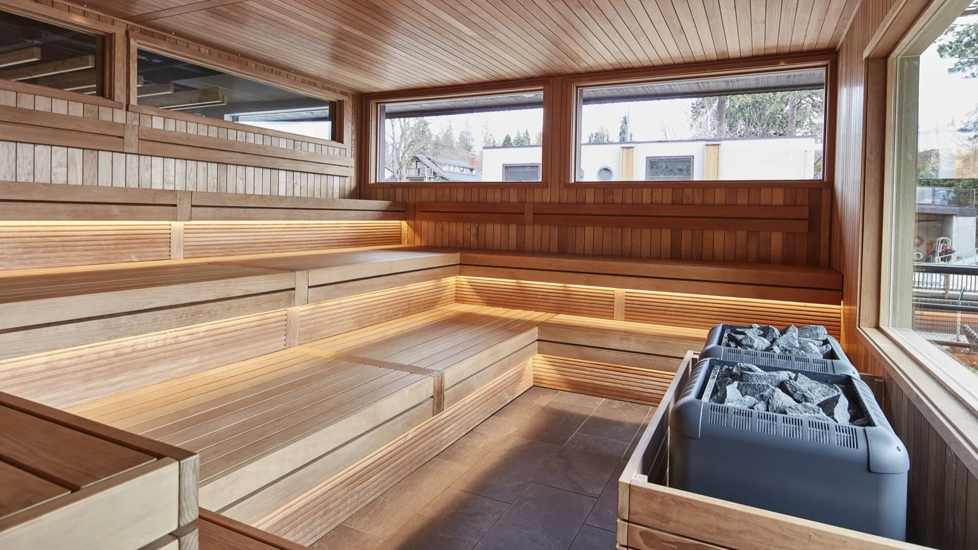 Interior of a custom cedar barrel sauna with tiered benches and large view windows
