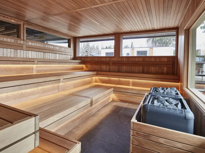 Interior of a custom cedar barrel sauna with tiered benches and large view windows