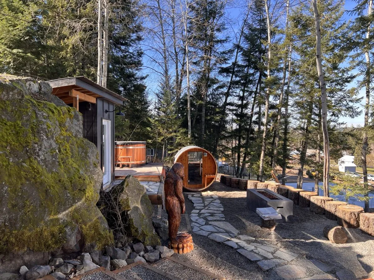 Wellness patio with a fire pit between the sauna and cold plunge