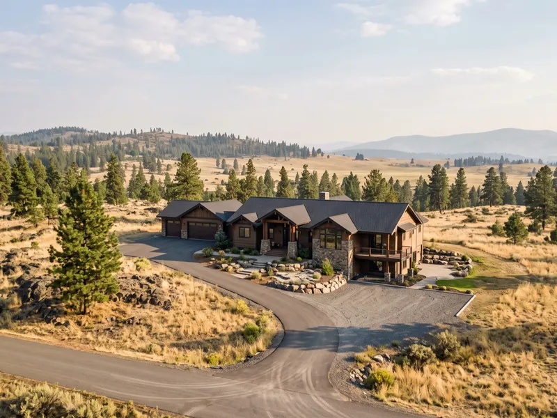 Aerial view of a craftsman-modern custom home on a pine and basalt lot in the Spokane, Washington area